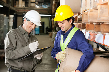 Image showing Foreman Looking At Supervisor Writing Notes