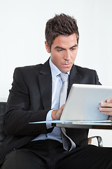 Image showing Young Businessman Using Digital Tablet In Office