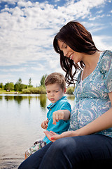 Image showing Mother and Son Playing near Pond