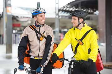 Image showing Courier Delivery Men With Bicycles Looking At Each Other