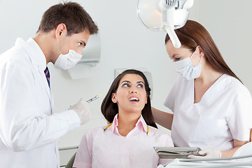 Image showing Dentist Looking At Nurse Comforting Patient