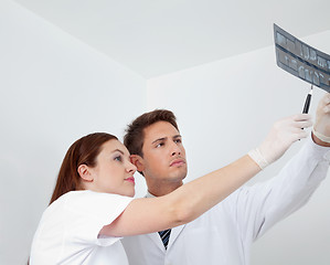 Image showing Doctor And Assistant Analyzing Patient's Report