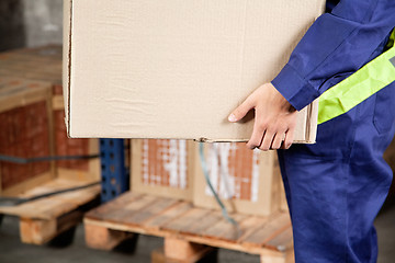 Image showing Foreman Carrying Cardboard Box At Warehouse