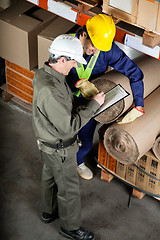 Image showing Foreman With Supervisor Writing Notes At Warehouse