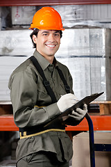 Image showing Happy Male Supervisor Writing On Clipboard