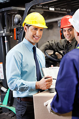 Image showing Male Supervisor Showing Clipboard To Foreman