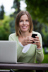 Image showing Attractive Woman in Park with Smart Phone