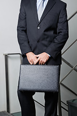 Image showing Midsection Of Young Businessman Carrying Briefcase