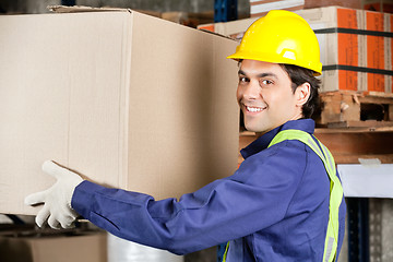 Image showing Young Foreman Lifting Cardboard Box