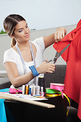 Image showing Designer Cutting Red Fabric