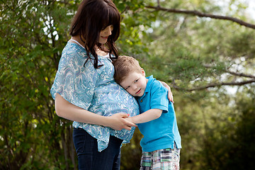 Image showing Son Listening to Pregnant Mother's Belly