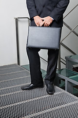 Image showing Businessman With Briefcase Standing By Steps