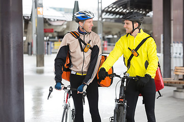 Image showing Courier Delivery Men With Bicycles Looking At Each Other