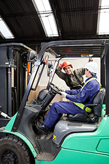 Image showing Forklift Driver Communicating With Colleague