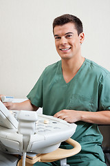 Image showing Male Technician Operating Ultrasound Machine