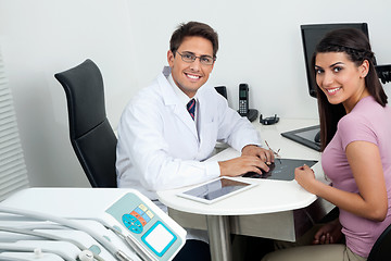 Image showing Happy Dentist And Patient At Office Desk