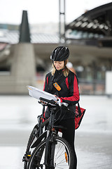 Image showing Female Cyclist With Courier Bag And Package On Street