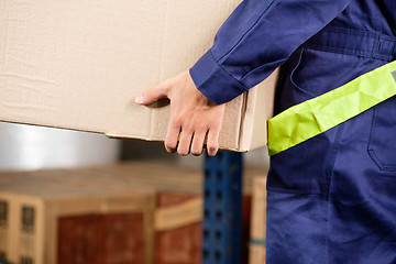 Image showing Foreman Carrying Cardboard Box At Warehouse