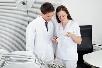 Image showing Dentist And Assistant With Dental Report