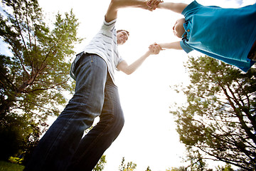 Image showing Father Spinning Son in Park