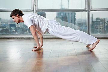 Image showing Young Man Practicing Yoga At Gym