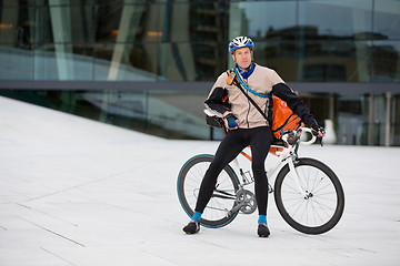 Image showing Male Cyclist With Courier Bag Sitting On Bicycle