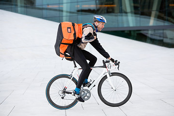 Image showing Male Cyclist With Backpack Riding Bicycle