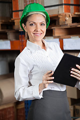 Image showing Female Supervisor With Book At Warehouse