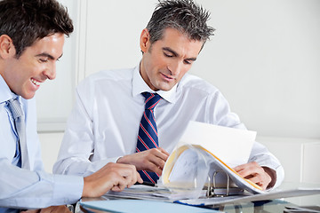 Image showing Businessmen Discussing Paperwork In Office