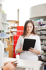 Image showing Pharmacist Helping Customer with Digital Tablet