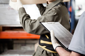 Image showing Foreman And Supervisor Working At Warehouse