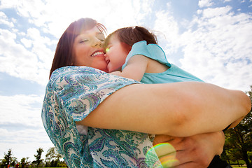 Image showing Mother and Daughter Hugging Outdoors