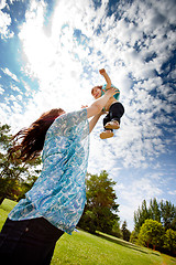 Image showing Mother Throwing Daughter in Air