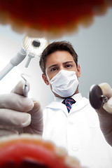 Image showing Dentist Examining Patient's Mouth