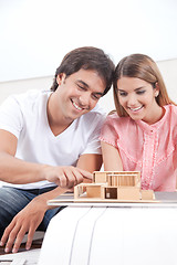 Image showing Couple Looking at House Model