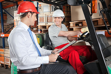 Image showing Forklift Driver Communicating With Supervisor