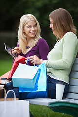 Image showing Women With Shopping Bags Using Tablet PC Outdoors