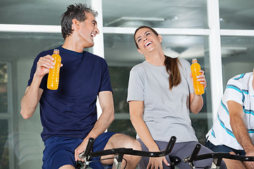 Image showing Happy Man And Woman Holding Juice Bottles