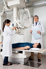 Image showing Radiologists With Patient In X-ray Room