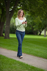 Image showing Woman Text Messaging In Park
