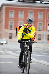 Image showing Male Cyclist With Courier Bag Using Walkie-Talkie