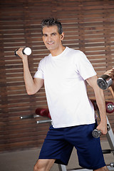 Image showing Happy Mature Man Lifting Dumbbells