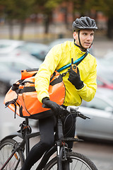 Image showing Male Cyclist With Courier Bag Using Walkie-Talkie