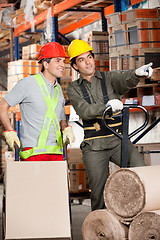 Image showing Foreman Showing Something To Coworker At Warehouse