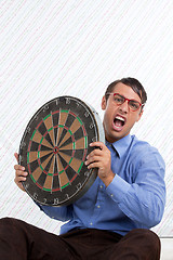 Image showing Man Holding a Dartboard