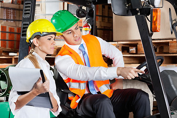 Image showing Male Supervisor Showing Something To Colleague At Warehouse