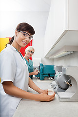 Image showing Dentist Holding Dental Plaster Mold With Assistant At Clinic