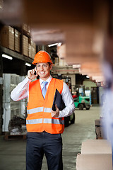 Image showing Male Supervisor Using Cell Phone At Warehouse