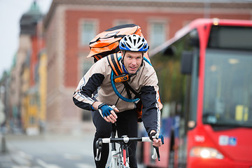 Image showing Male Cyclist With Courier Delivery Bag Riding Bicycle