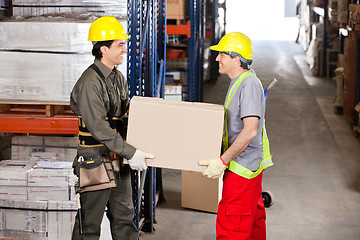 Image showing Foremen Carrying Cardboard Box At Warehouse